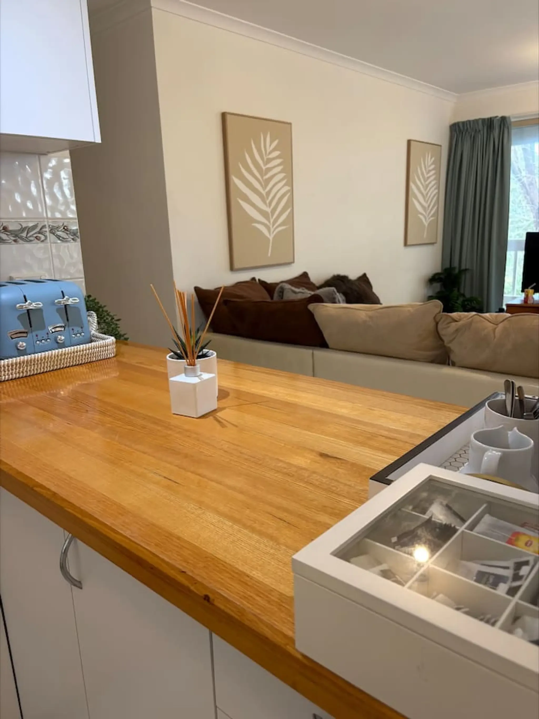 Pine Lea Lodge kitchen bench with living area view