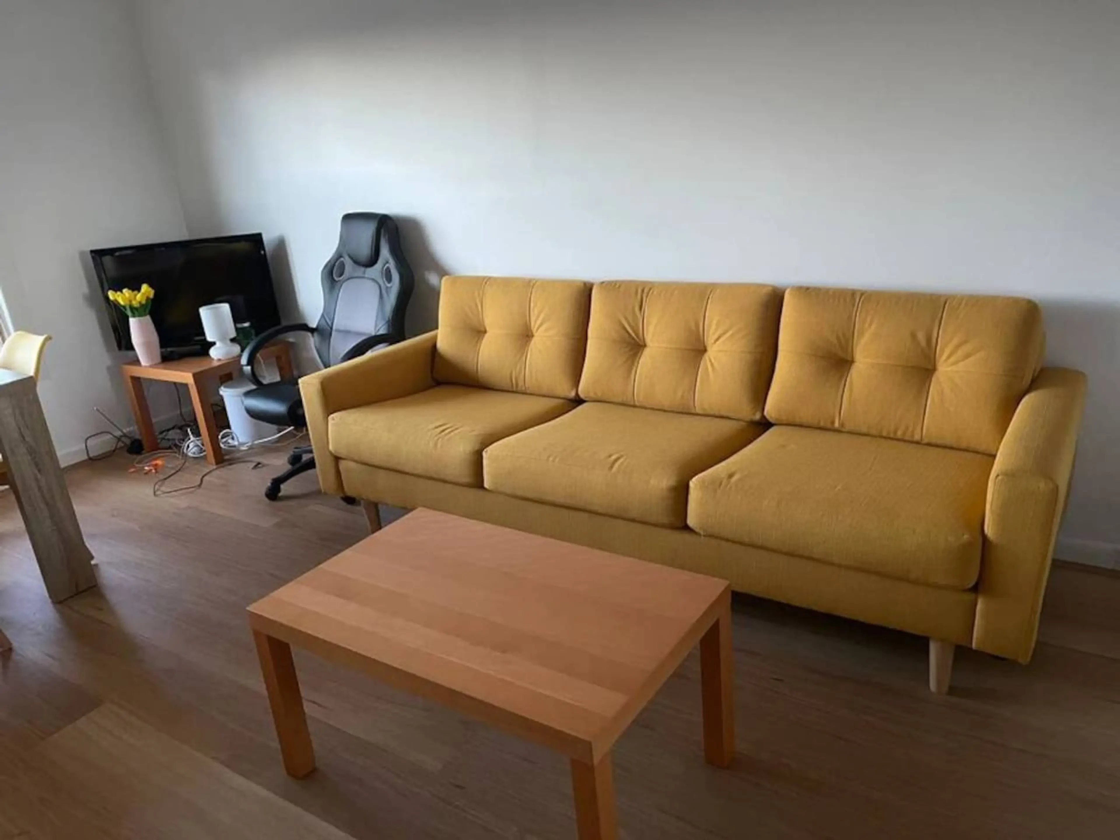 Cosy Tin Shack living room with yellow sofa