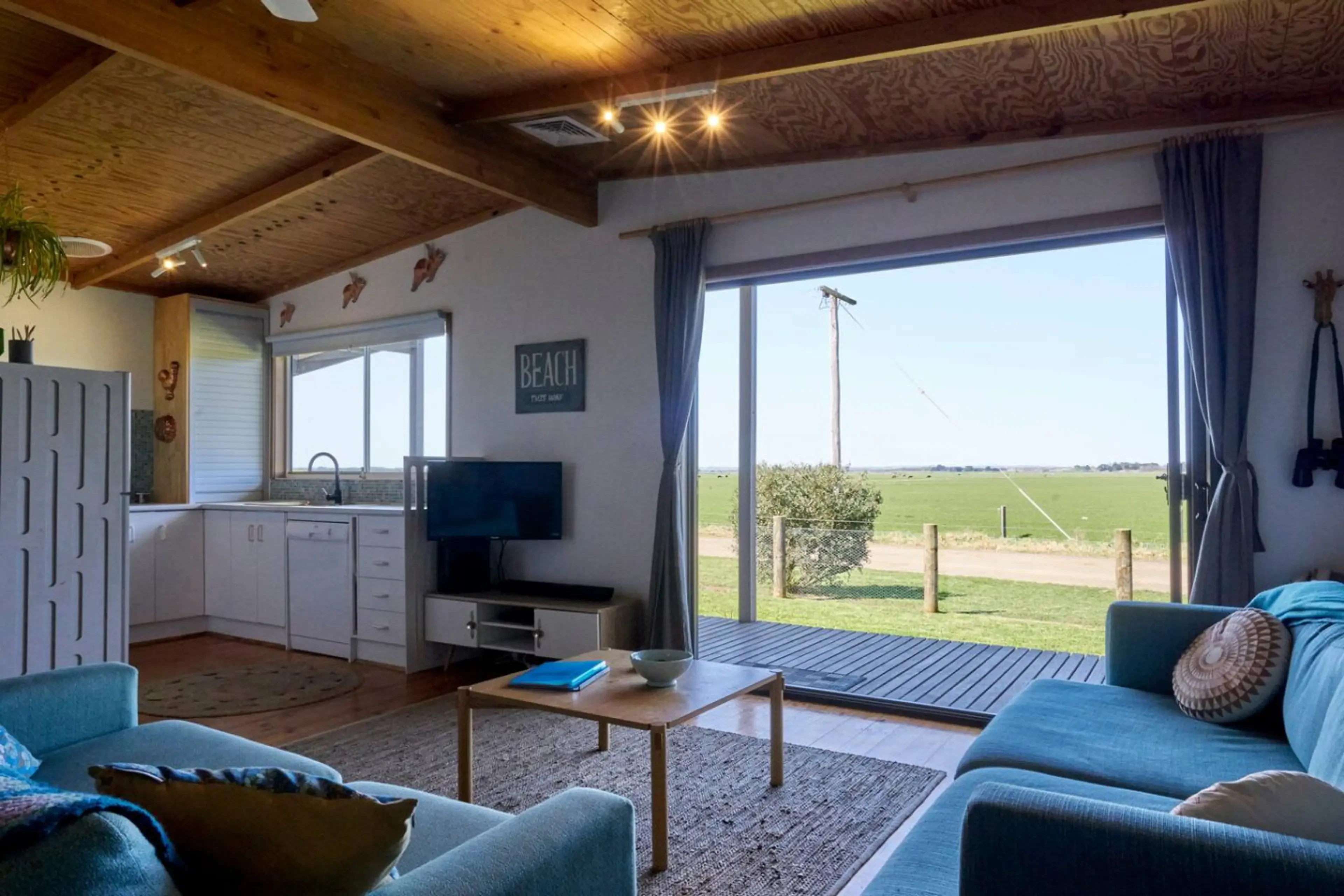 Far View living room with coastal views and timber ceiling