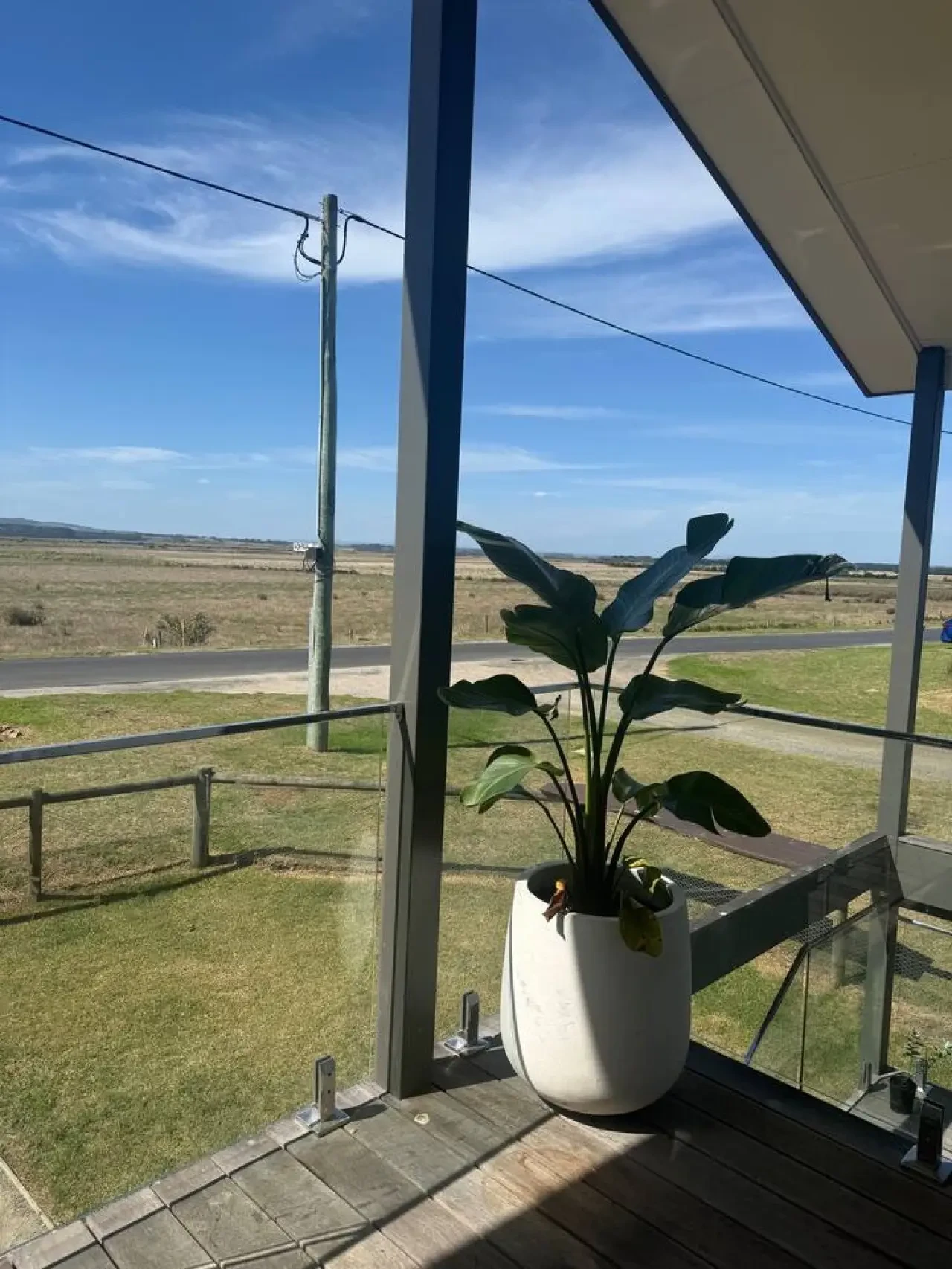 Lancaster Lodge deck with plant and sweeping rural views