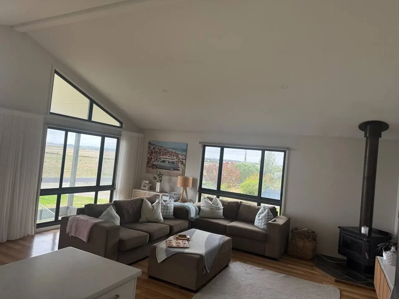 Lancaster Lodge living room with large windows and wood fire