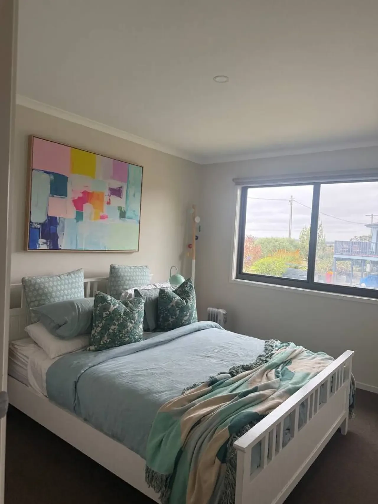Lancaster Lodge bedroom with teal bedding and colourful artwork