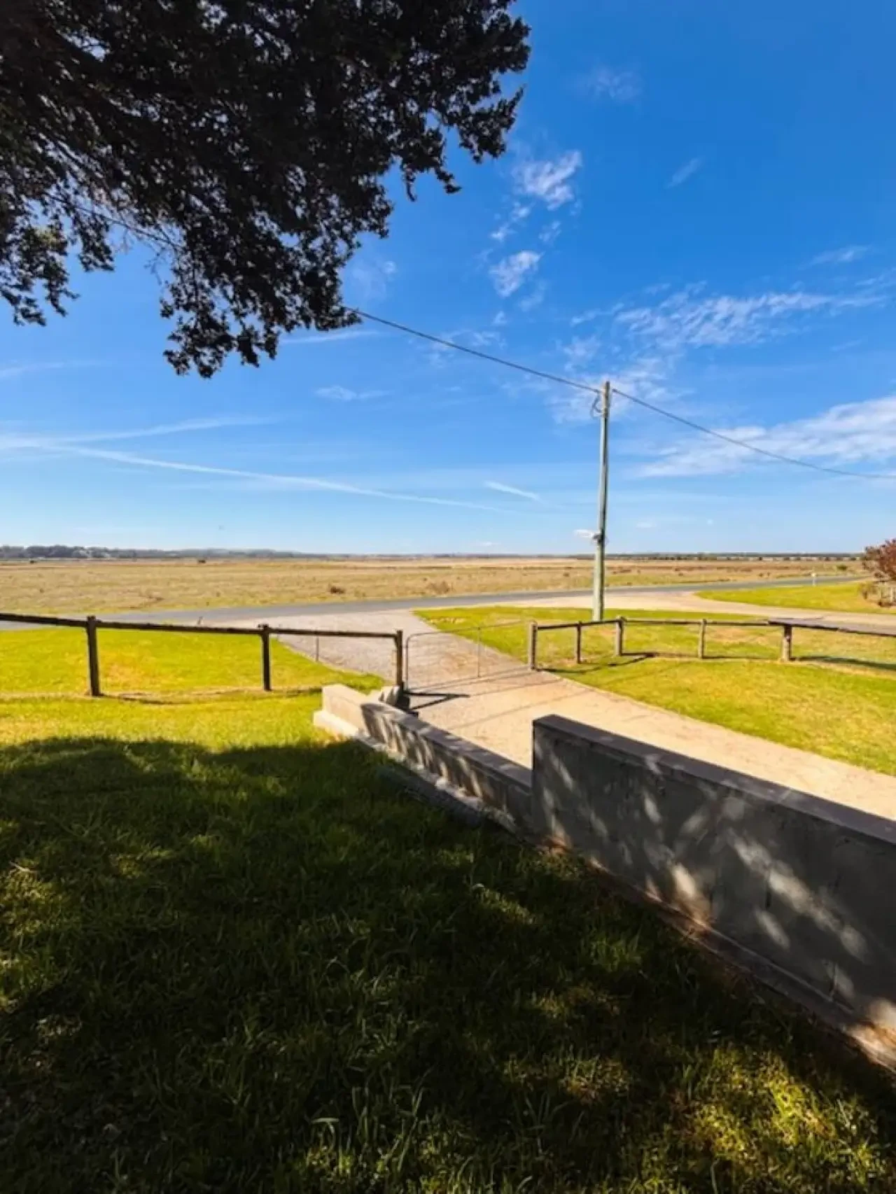 Lancaster Lodge front yard with rural paddock and inlet views