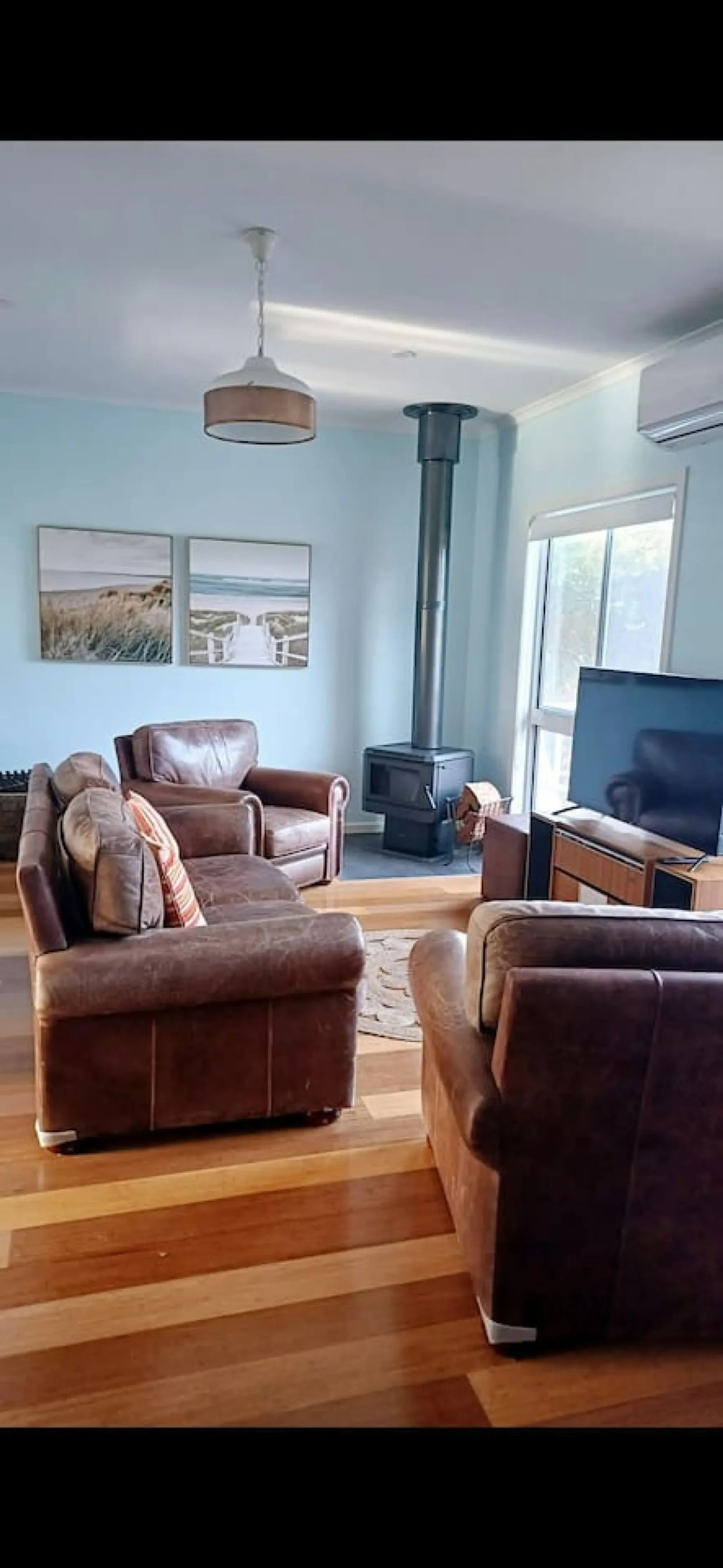 Ocean Blue — living room with wood fire and leather sofas