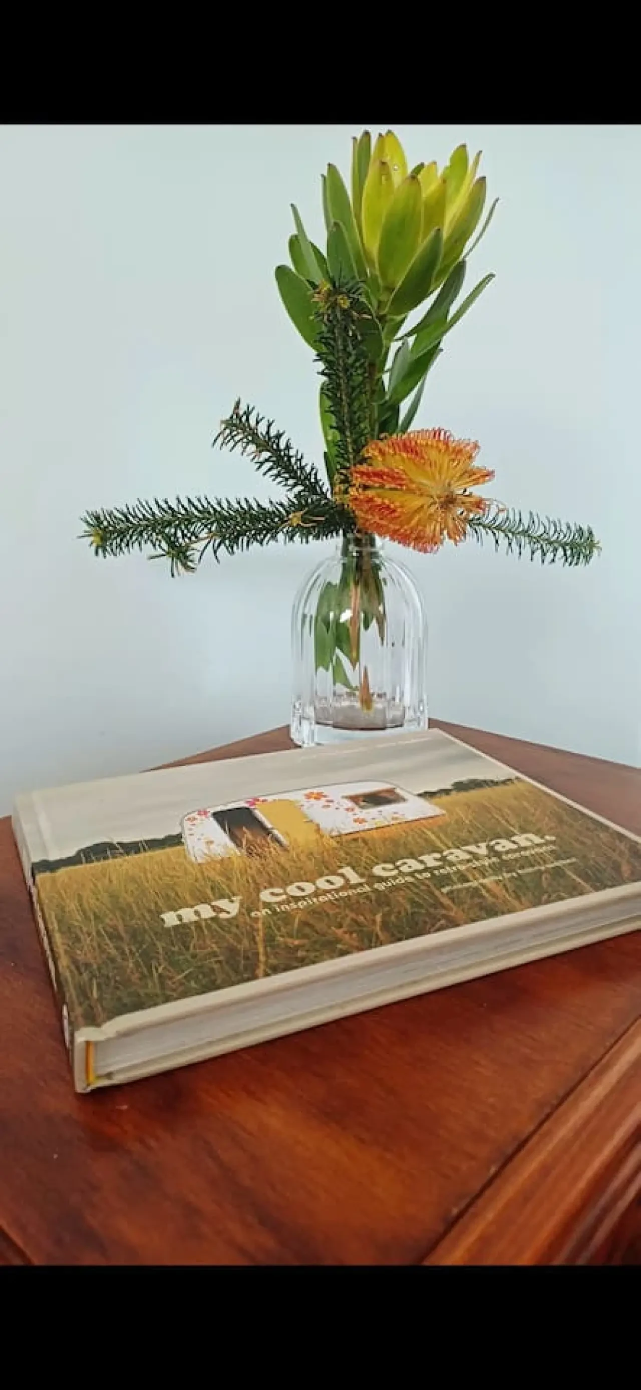 Ocean Blue — native flowers and book on bedside table
