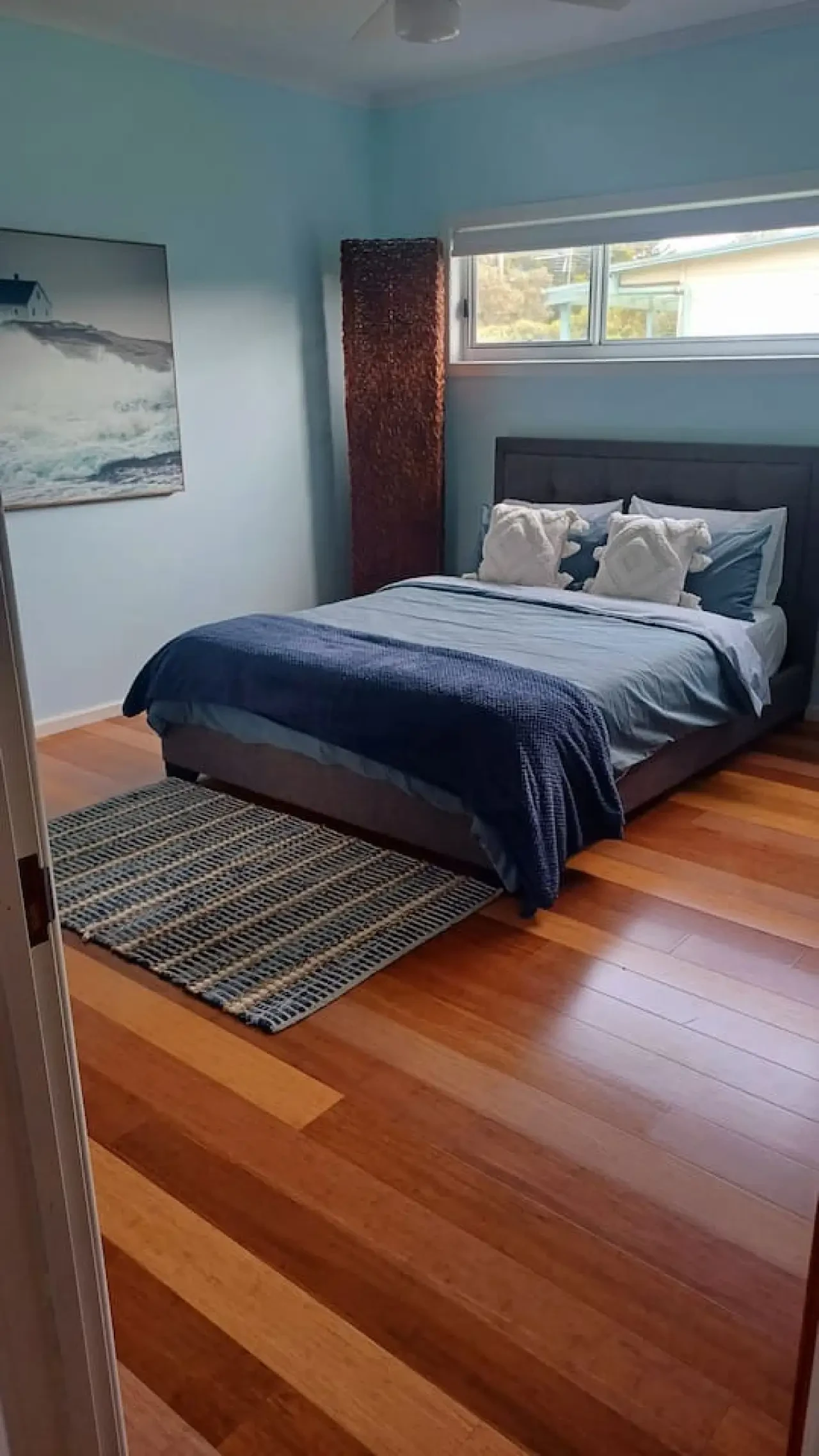 Ocean Blue — bedroom with turquoise walls and timber floors