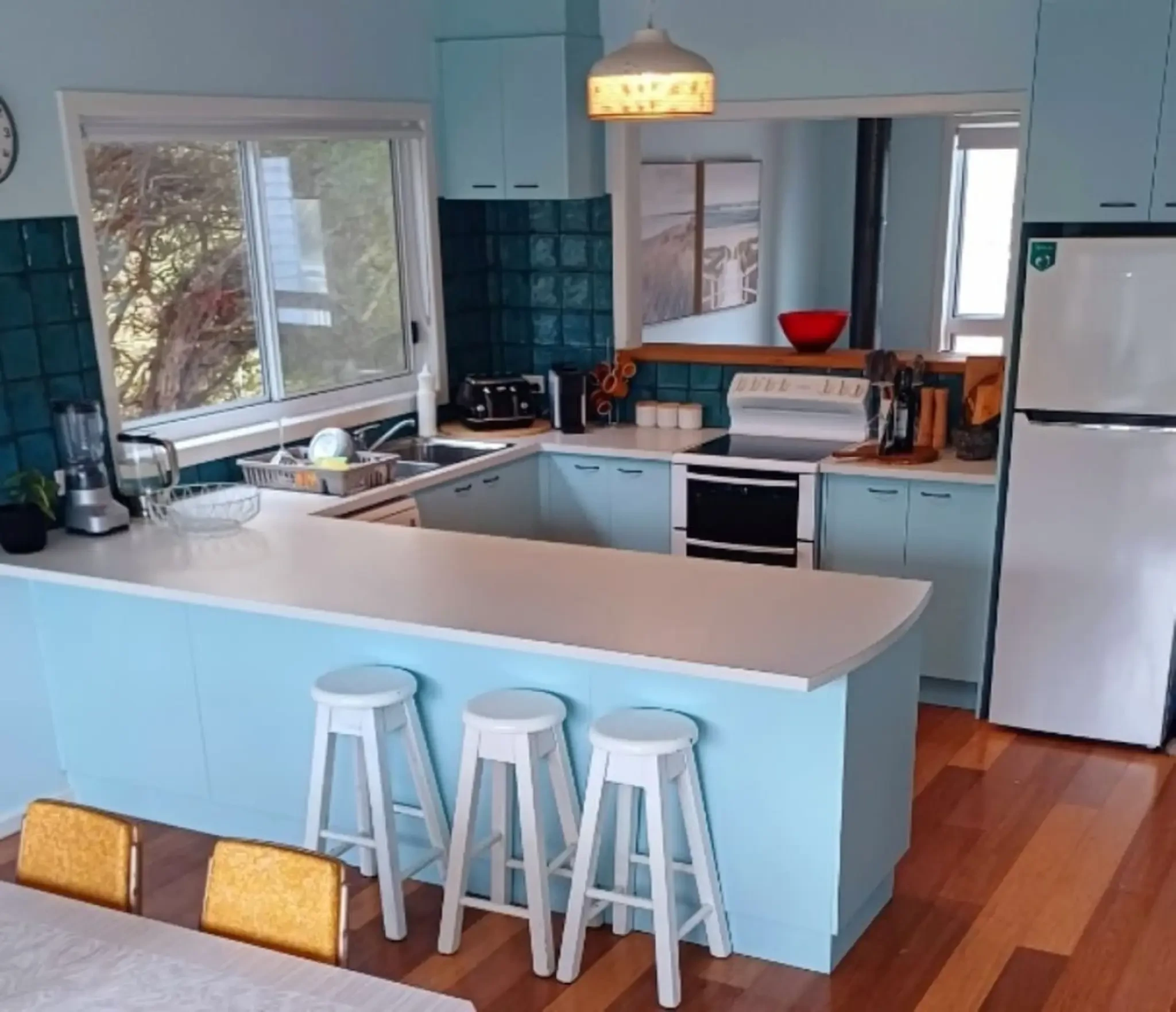Ocean Blue — blue kitchen with teal tile backsplash and bar stools