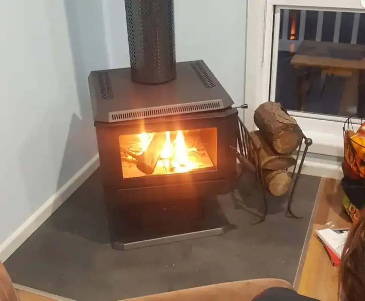 Ocean Blue — wood fire heater burning in living room corner