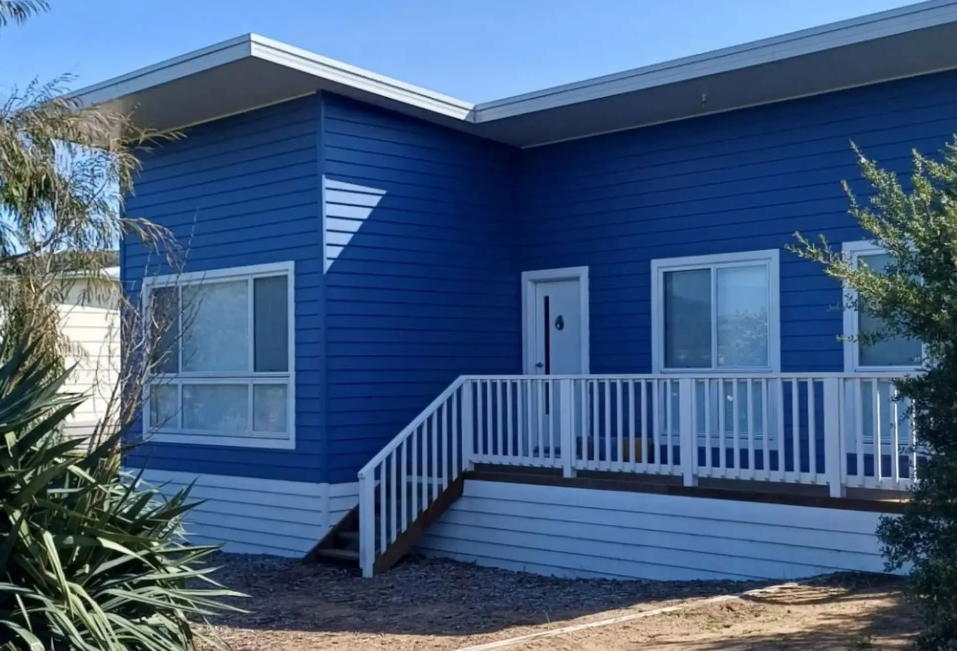 Ocean Blue — blue and white exterior with front deck and stairs