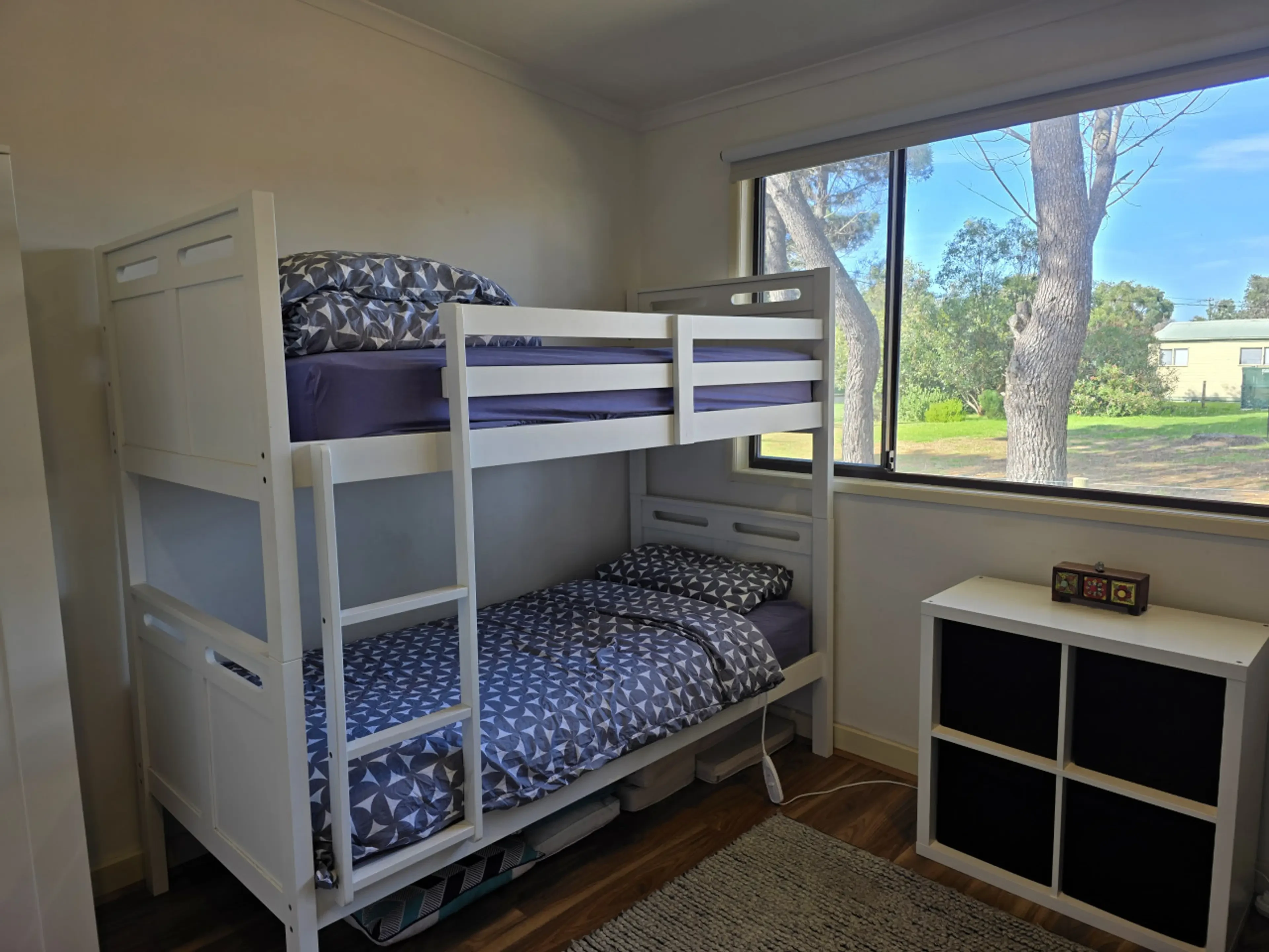 Bunk room with single bunk bed and garden view