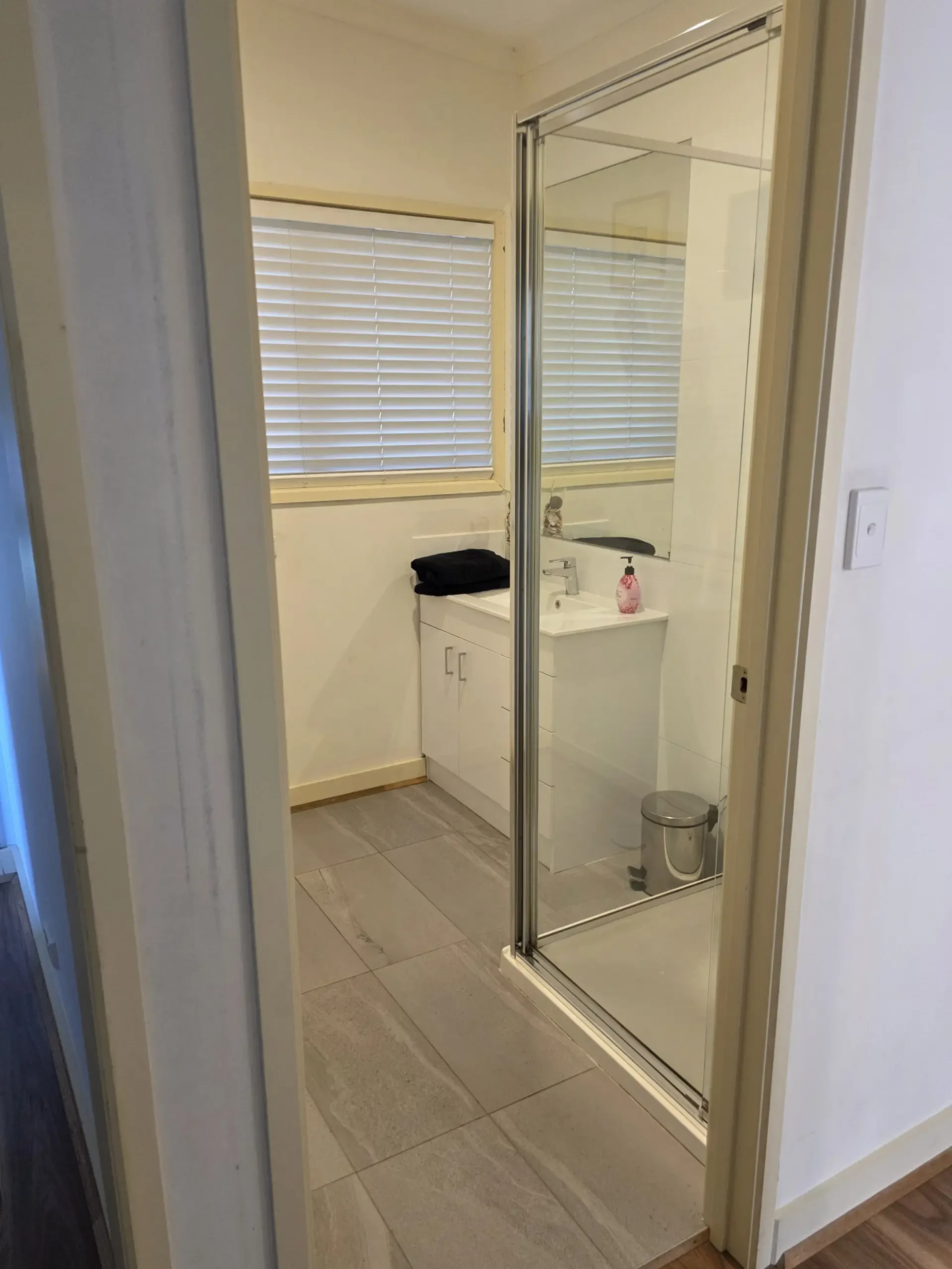 Bathroom with shower enclosure and vanity
