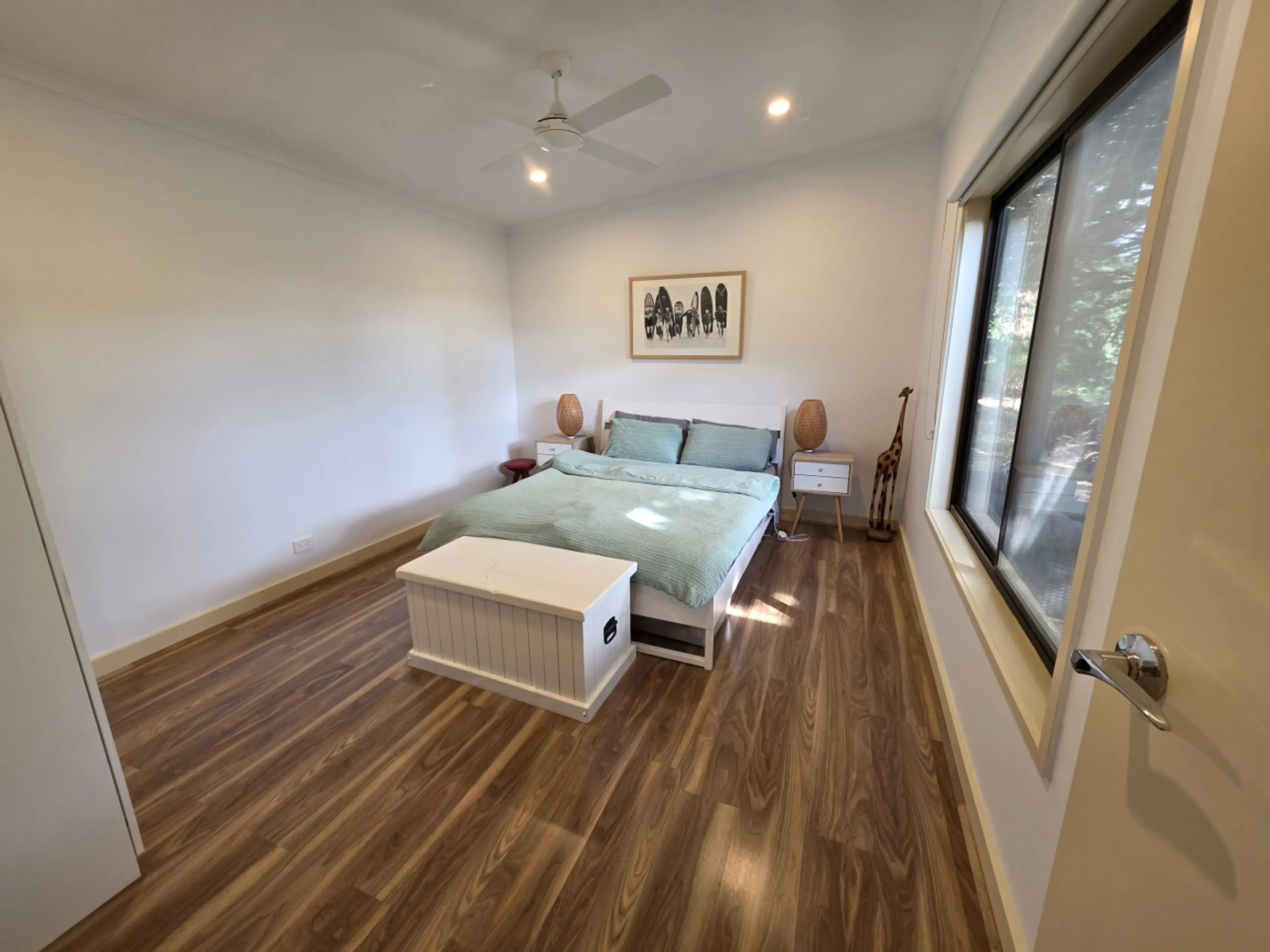 Master bedroom wide view with large windows