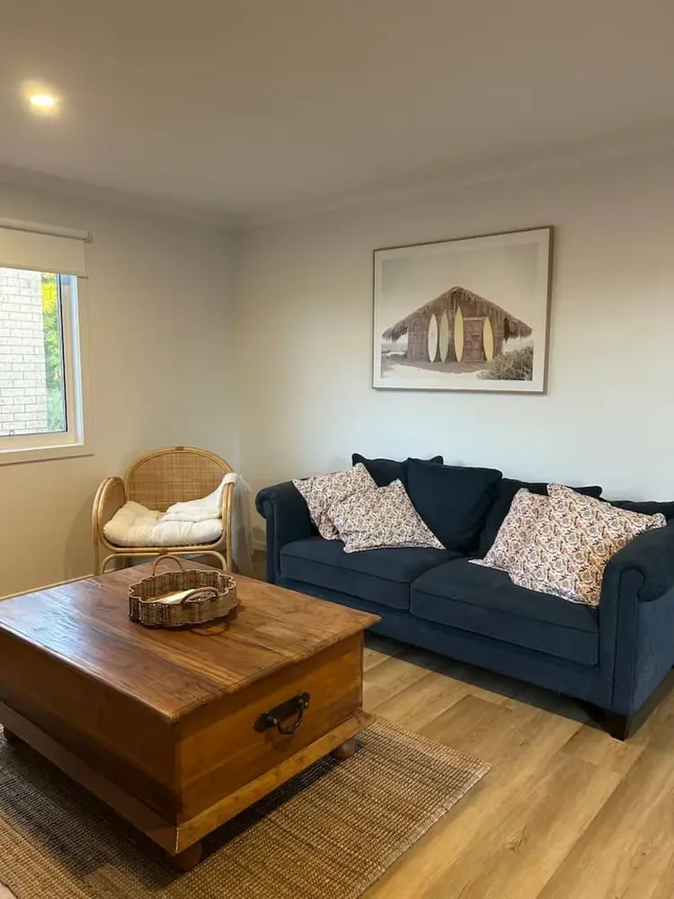Roo Views lounge with navy sofa and rattan chair