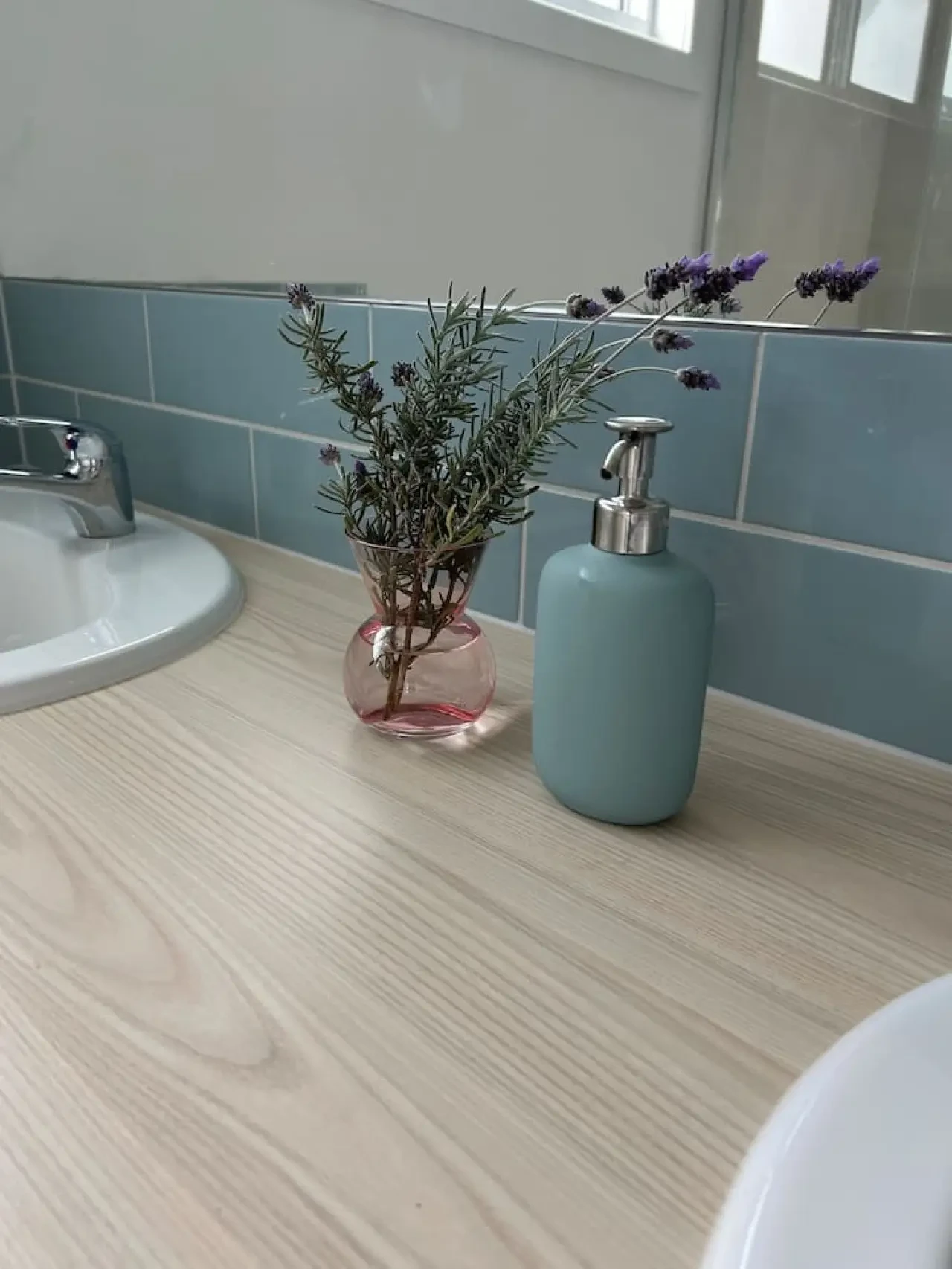 Roo Views bathroom vanity detail with teal tiles and lavender