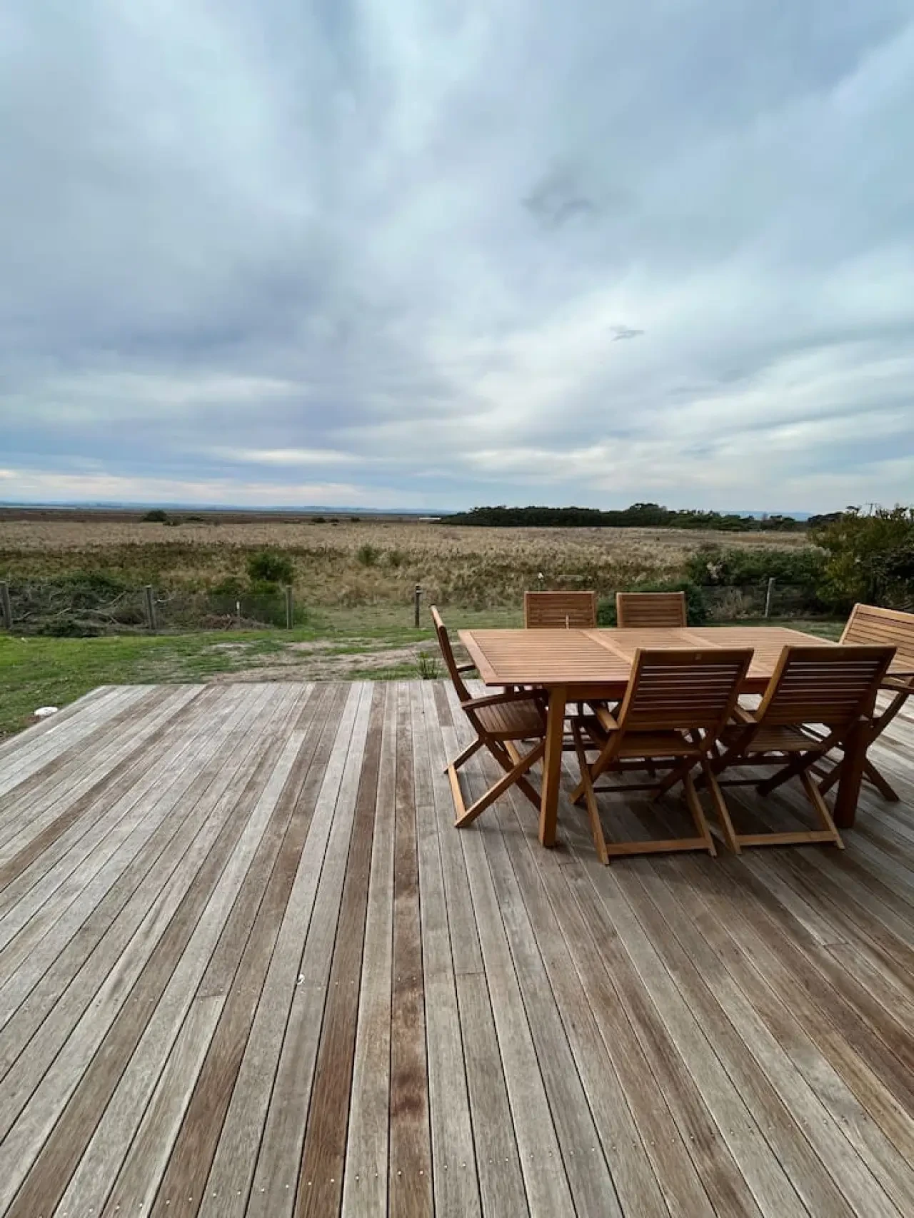 Roo Views deck with teak dining set overlooking wetlands