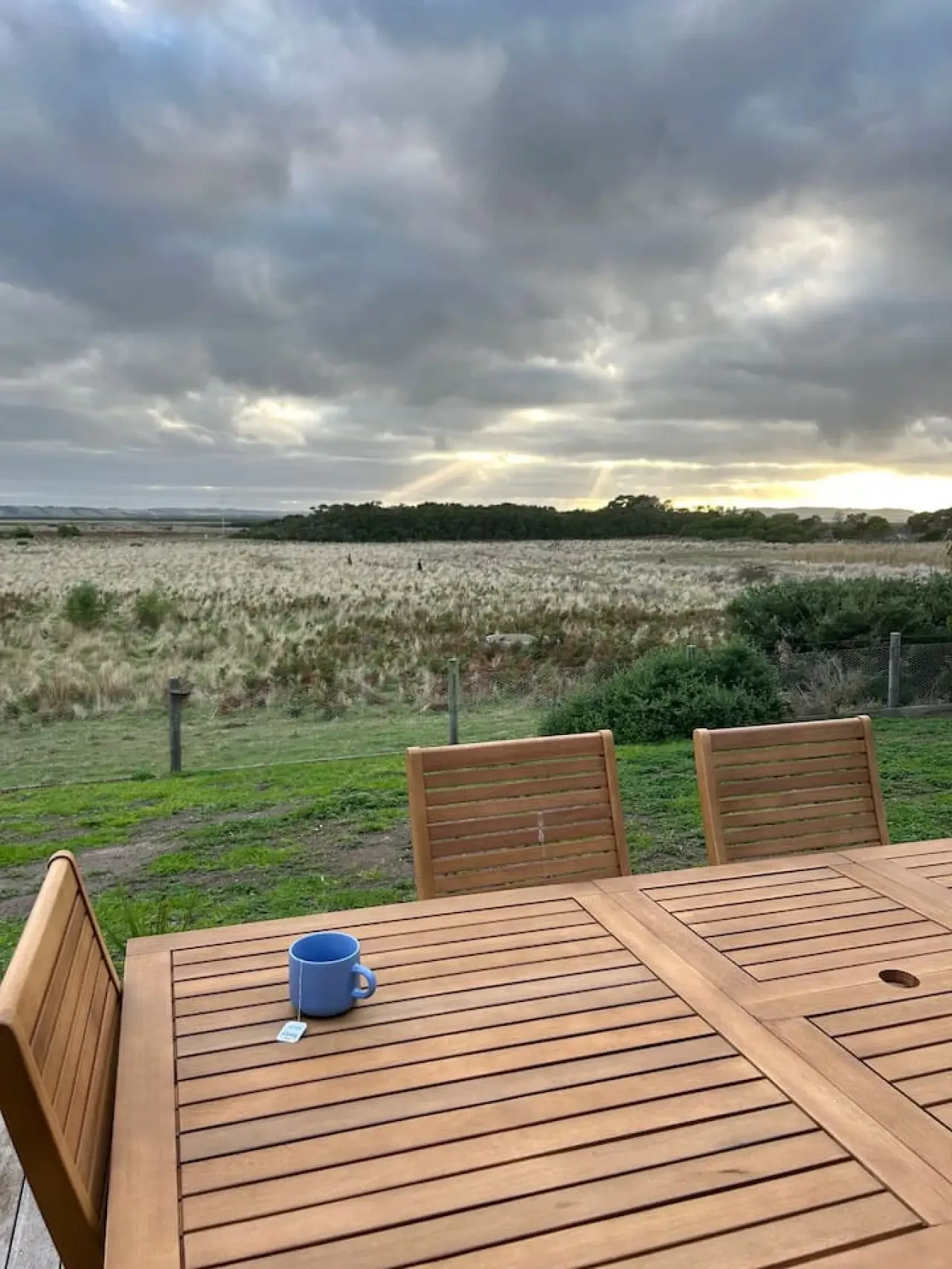 Roo Views deck with teak dining set and BBQ