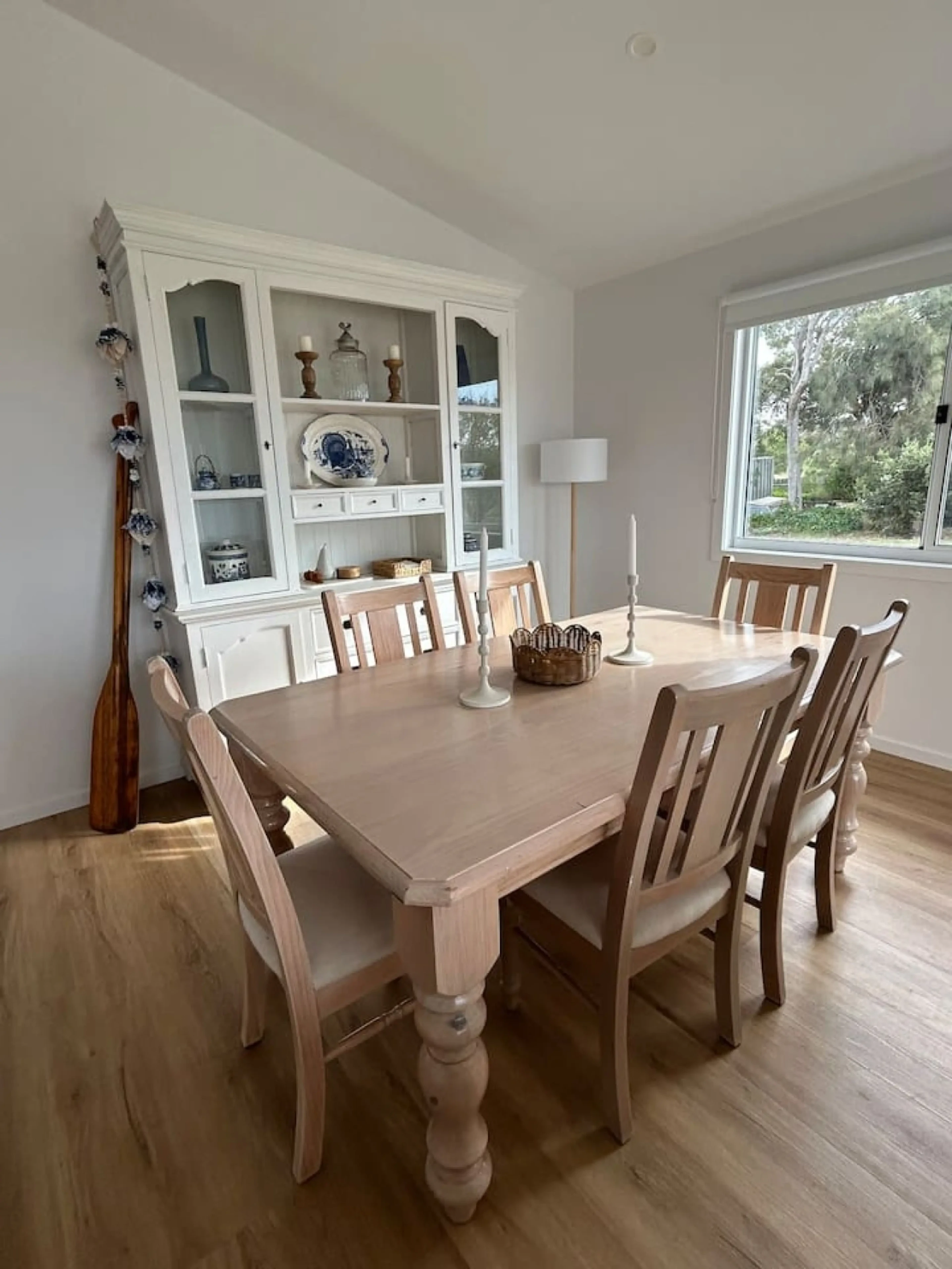 Roo Views dining room with timber table and hutch