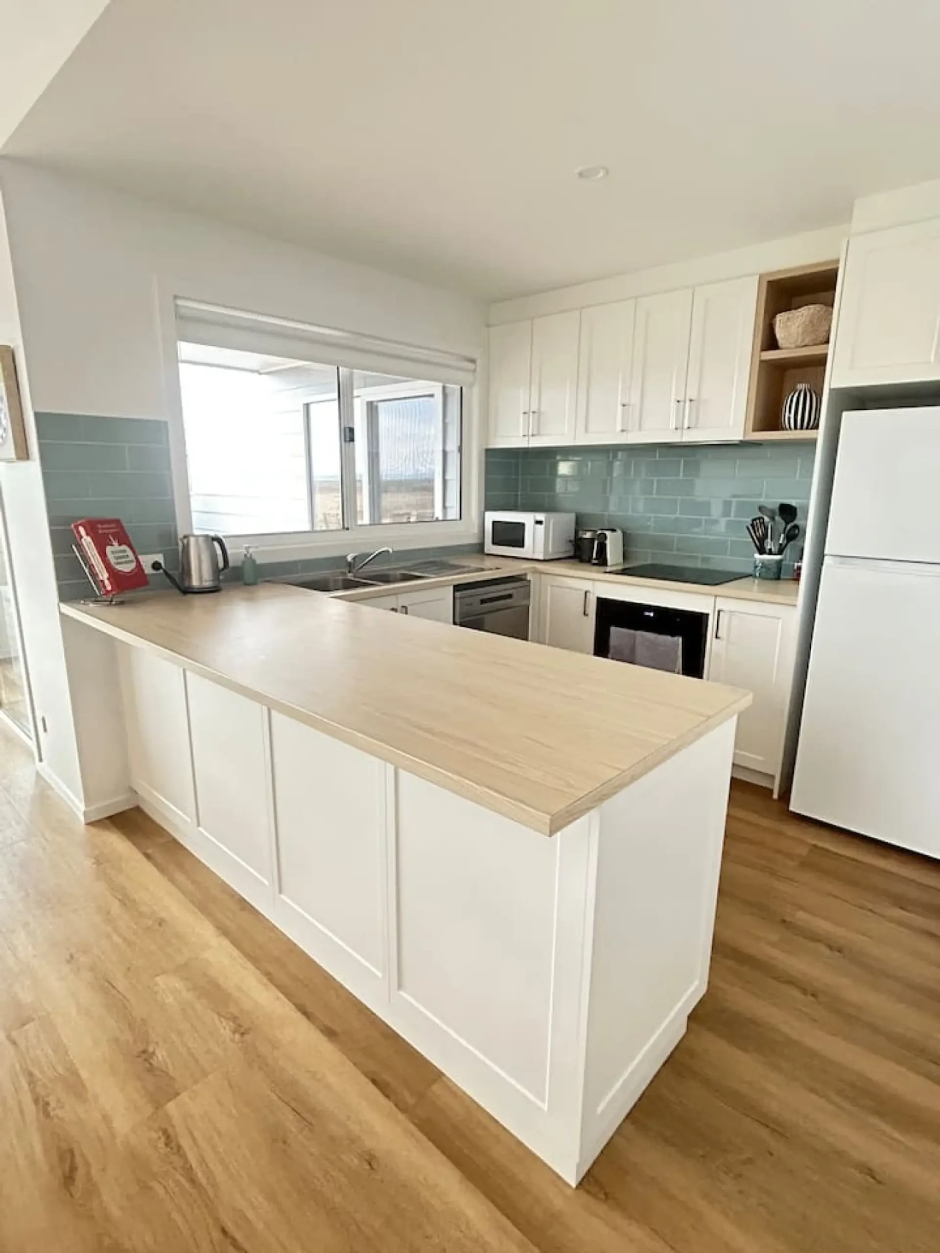 Roo Views kitchen with sage green tile backsplash