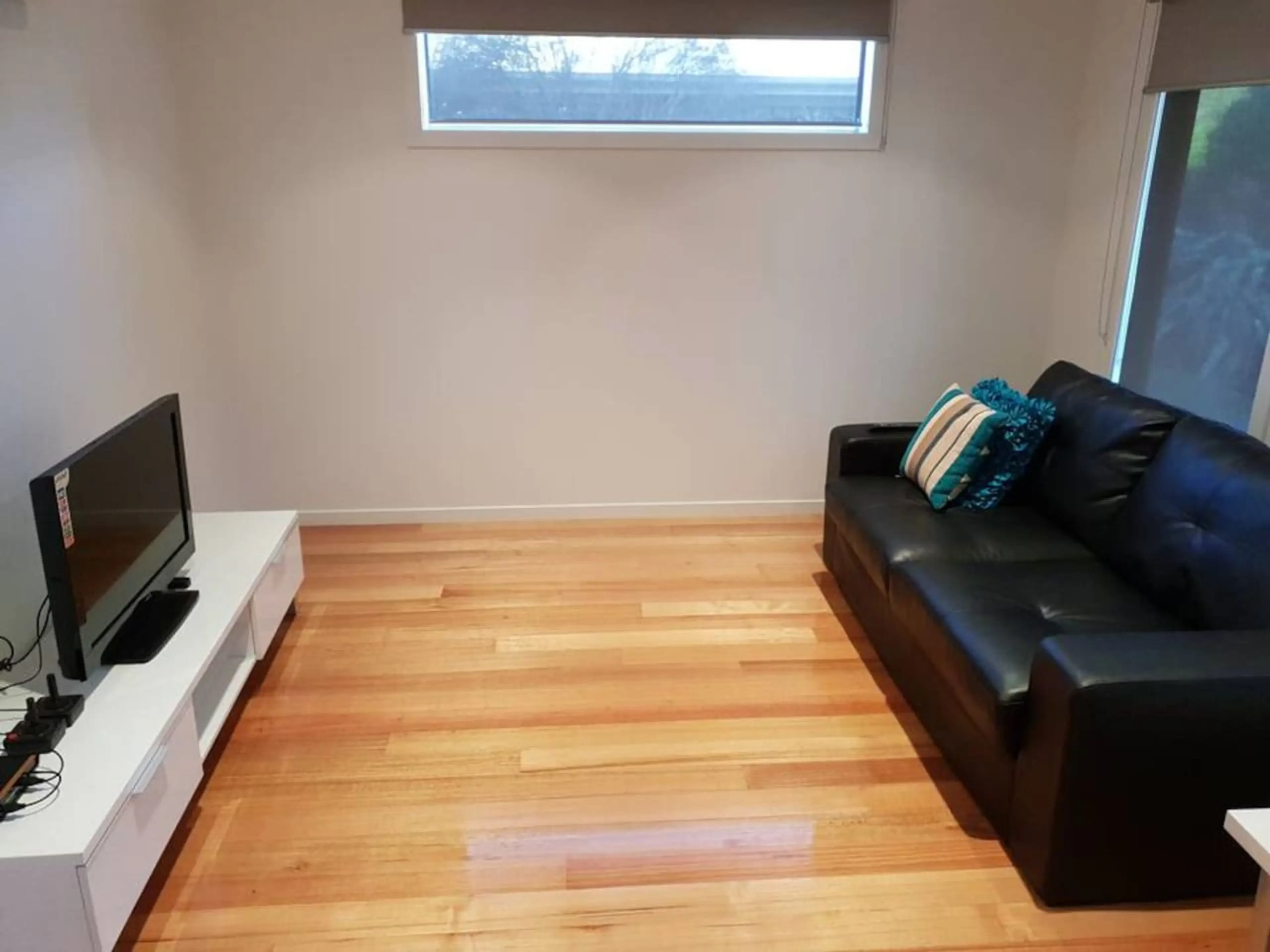 Venus Haven lounge room with TV and timber floors