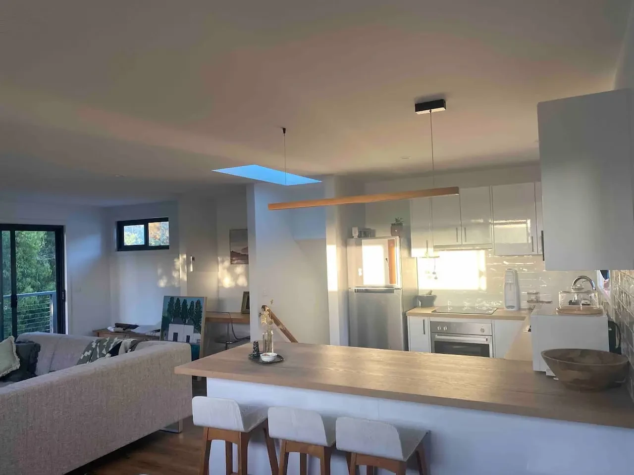 Open-plan kitchen and living area with skylight
