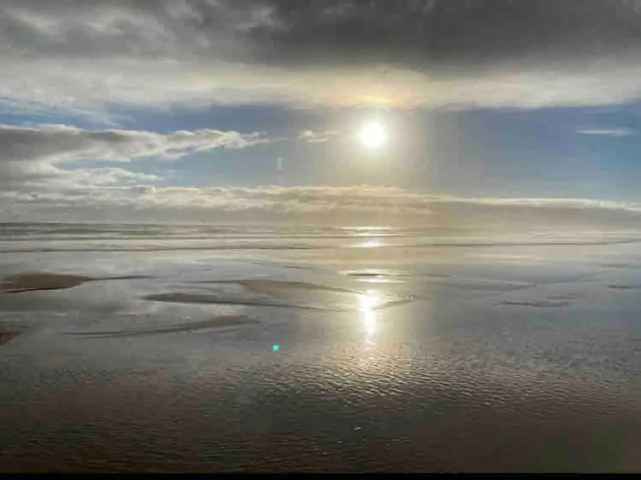 Venus Bay beach with sun reflecting off wet sand