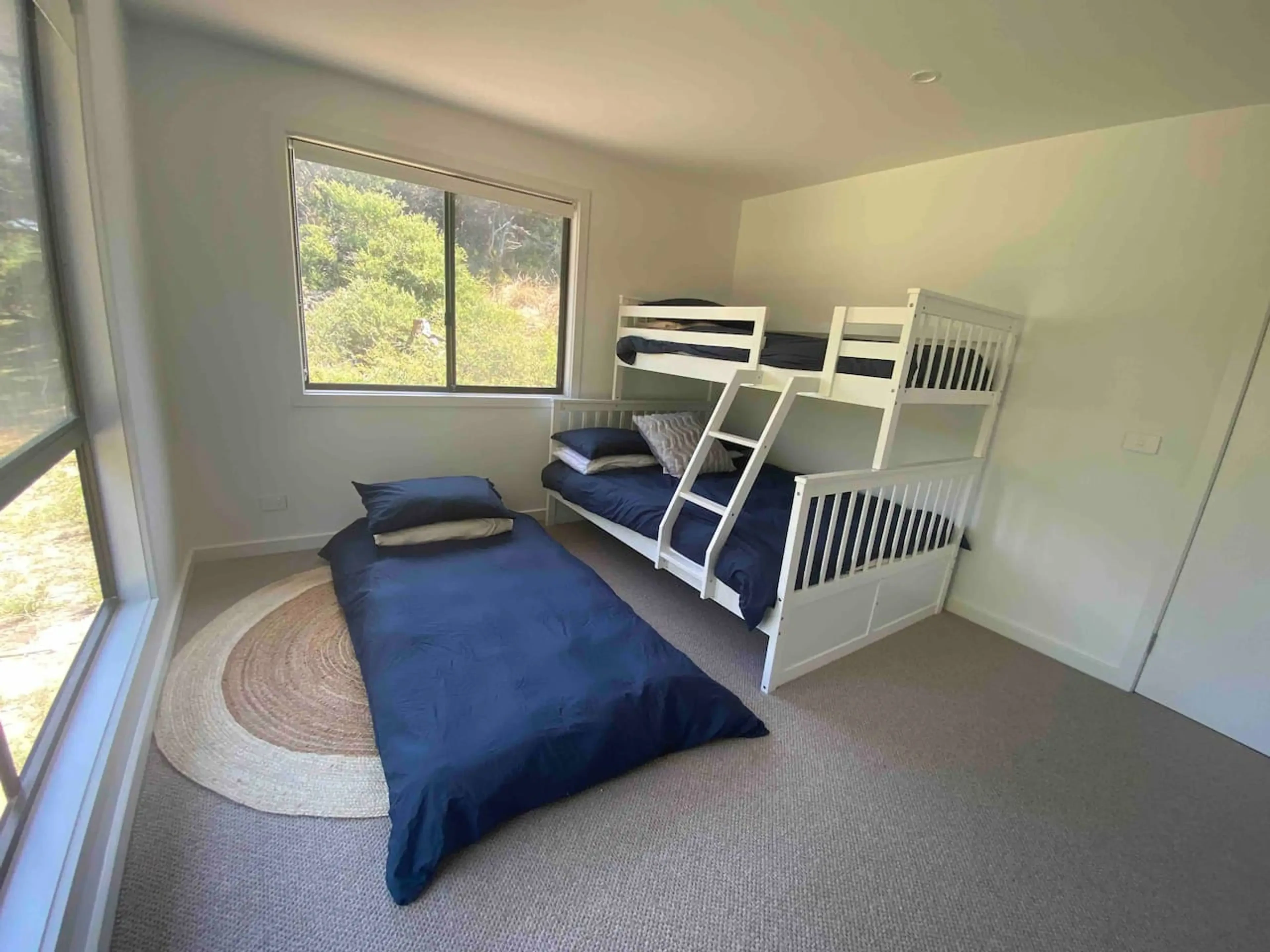 Bedroom 3 with bunk beds and single mattress on floor
