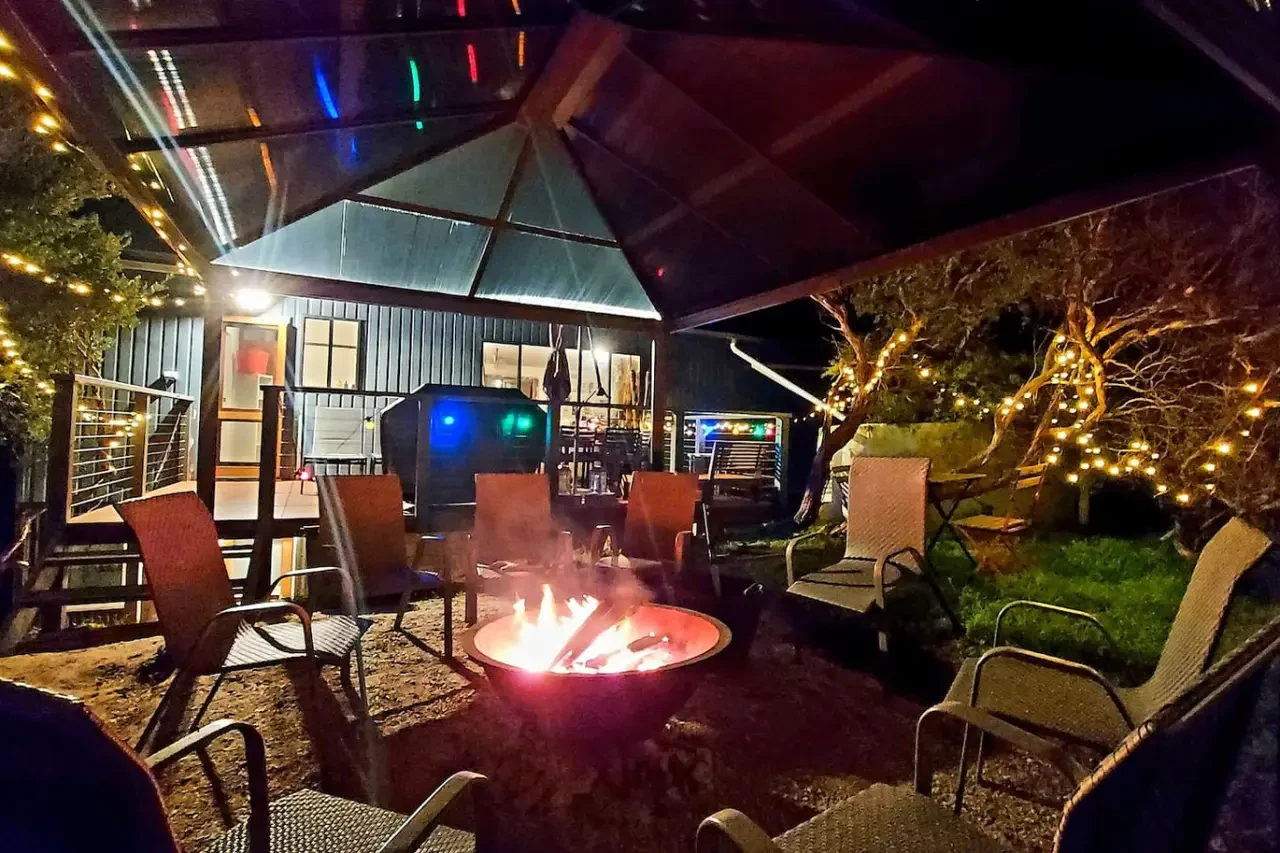 Retro Dunes backyard fire pit patio at night